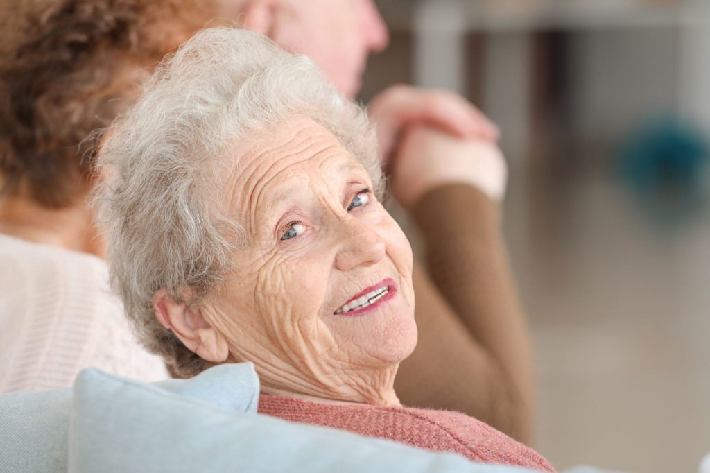 happy senior woman looking back and smiling