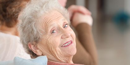 happy senior woman looking back and smiling