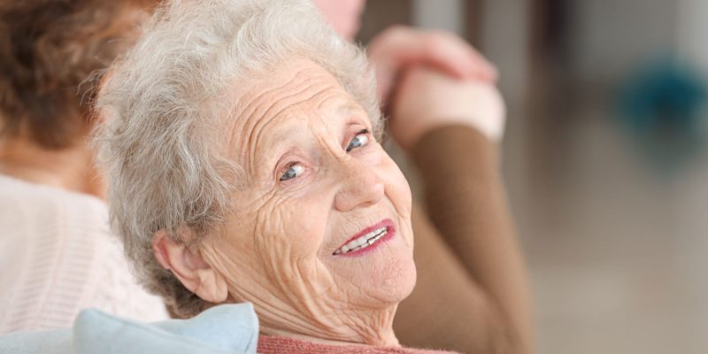 happy senior woman looking back and smiling