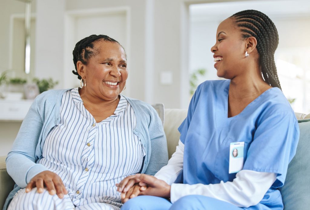 african-american nurse with african-american patient happy smiling