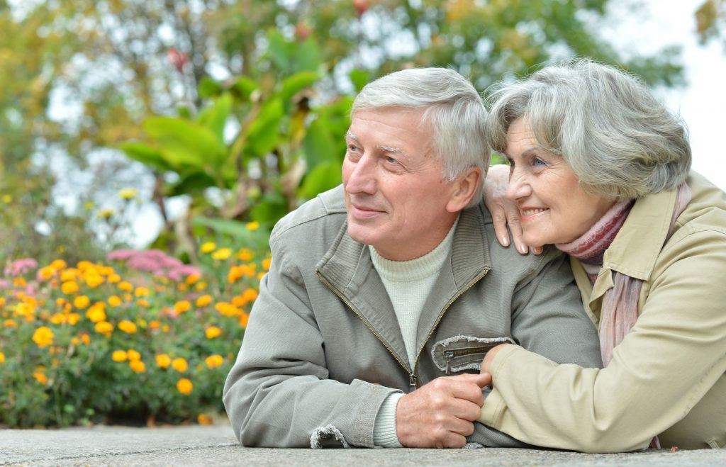 retirement couple smiling outside