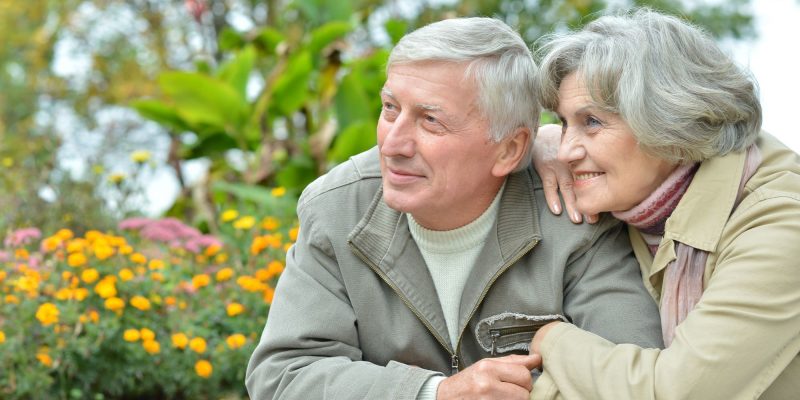 retirement couple smiling outside