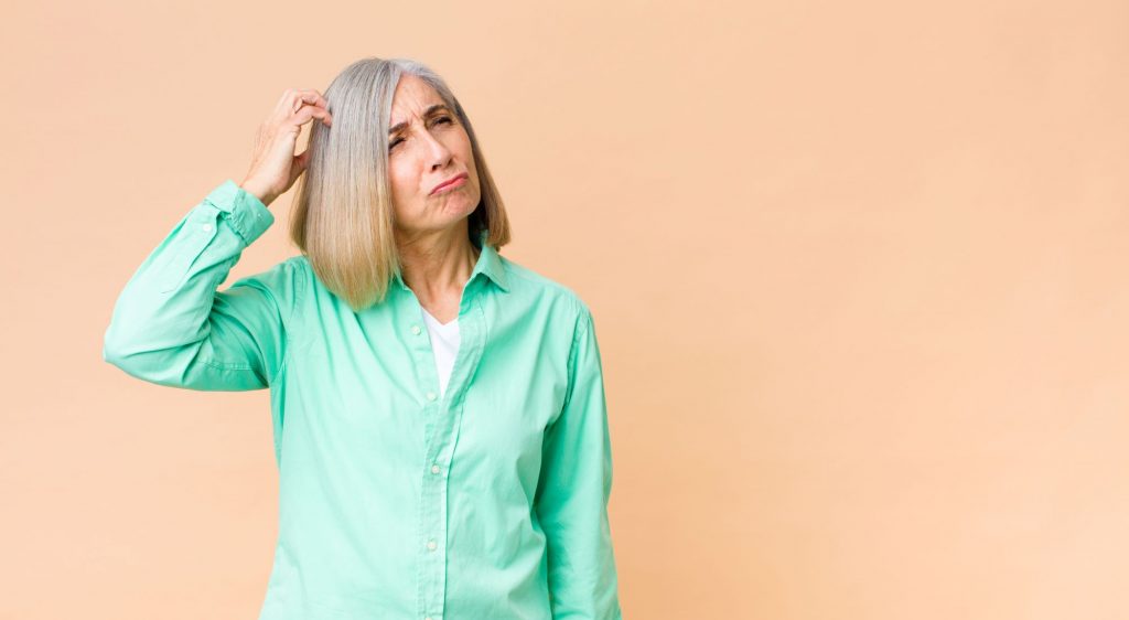 seninor woman scratching head thinking What's the Difference Between a Revocable Trust and an Irrevocable Trust?