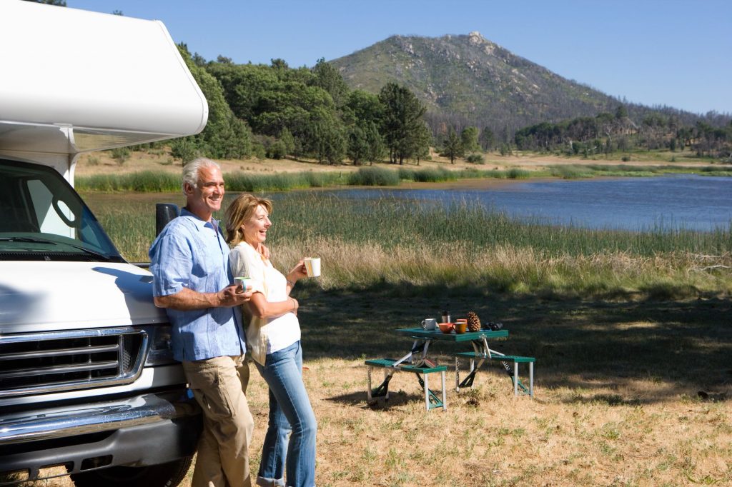 retired couple with r and mountain scenic background