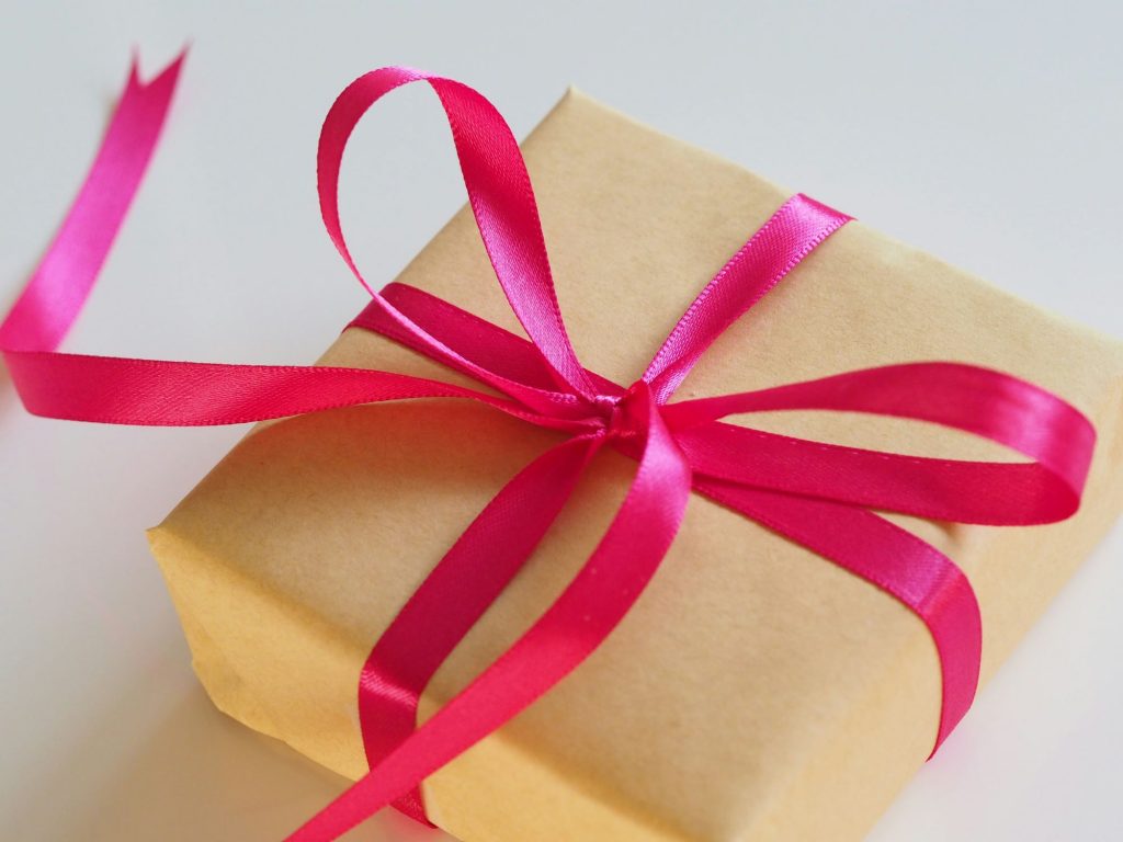 simple gift box with a pink ribbon tied in a bow