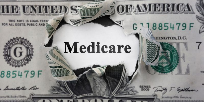 medicare in the center of a dollar bill