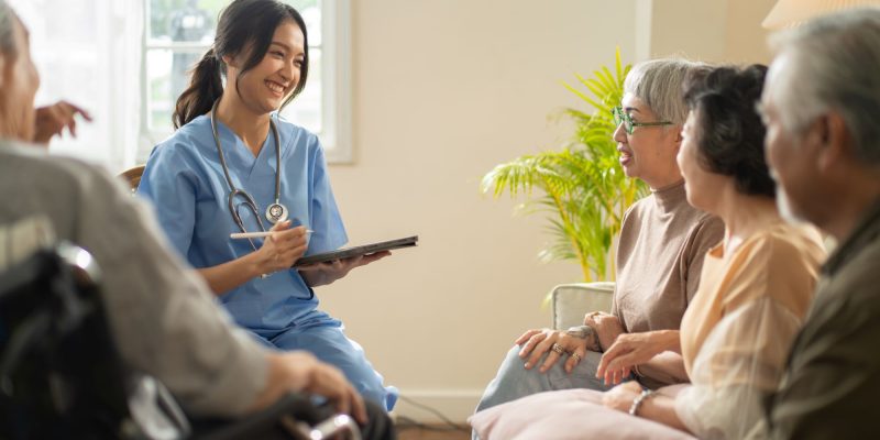 nurse and adult day health care participants in a group setting