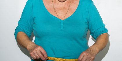 senior woman measuring waist, weight-loss concept