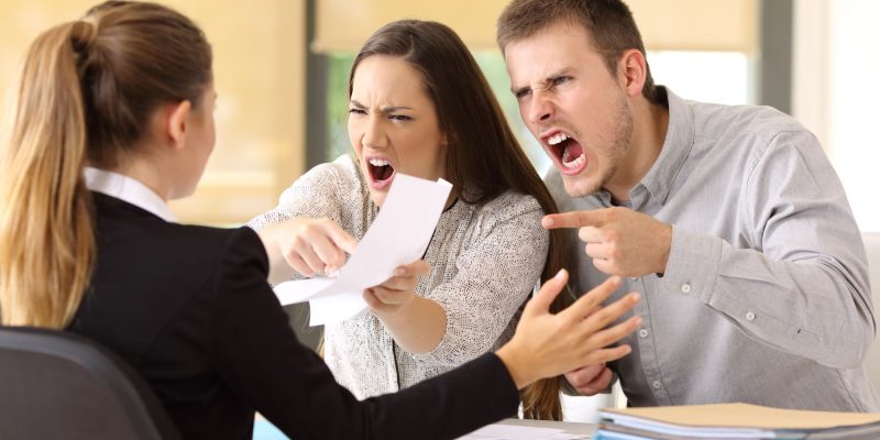 angry couple yelling at a lawyer