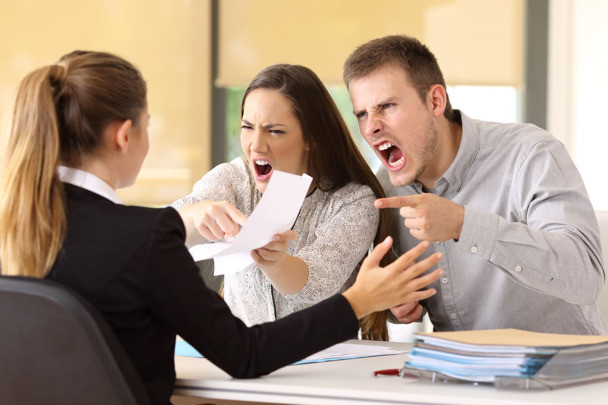angry couple yelling at a lawyer