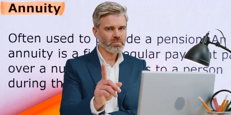 retirement planning man sitting in front of a computer and the definition of annuity but with one hand up gesturing no