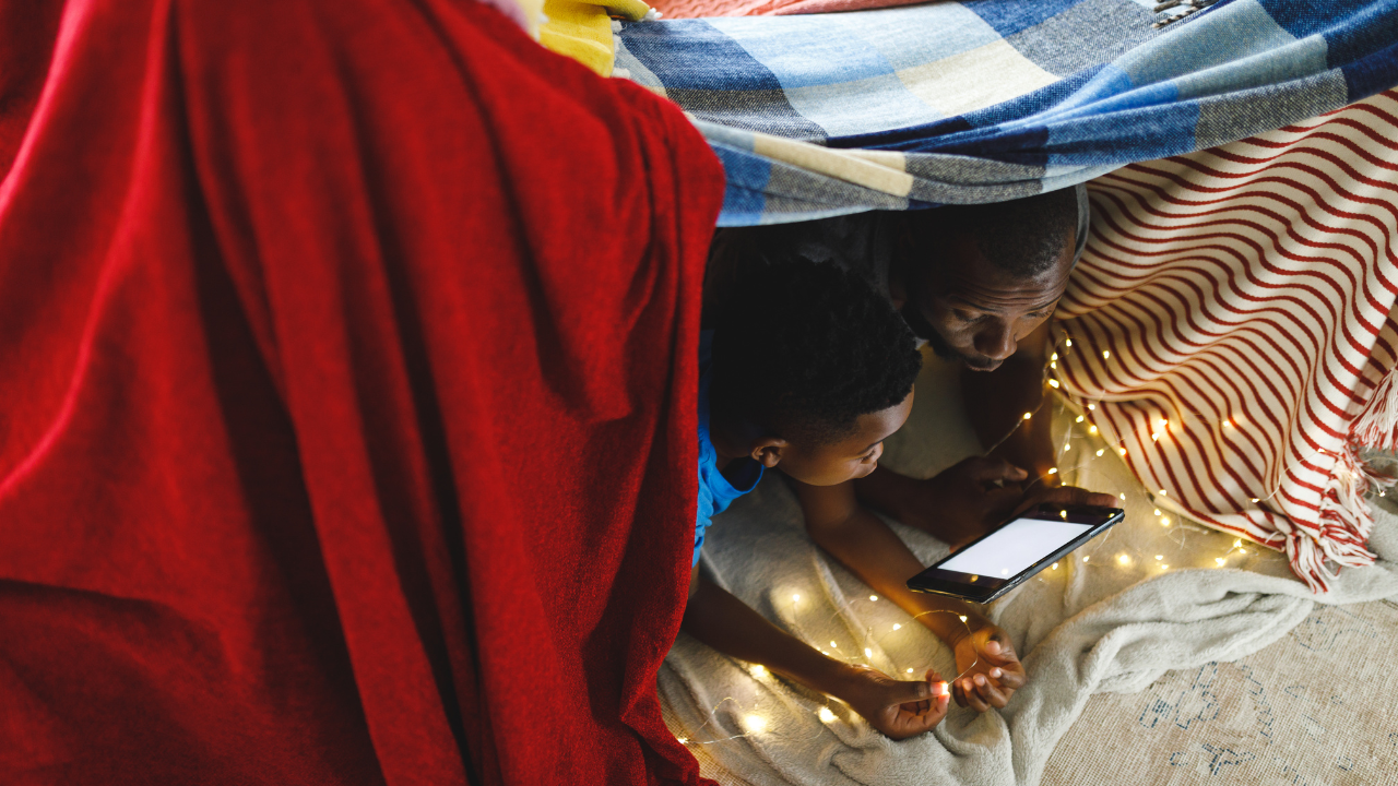 blanket fort with young boy and father/grandfather