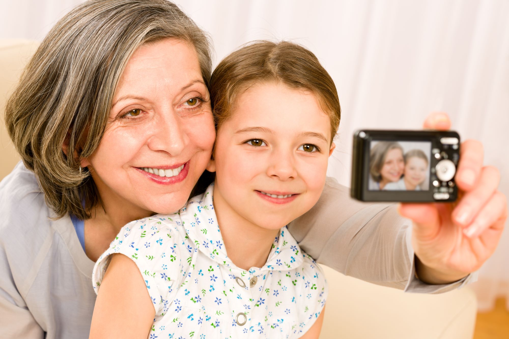 grandma taking a picture with her granddaughter