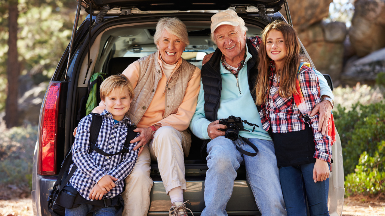 grandparents and grandchildren sitting in the back of a car