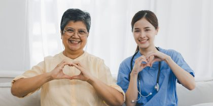 nurse and assisted living community resident doing heart hands