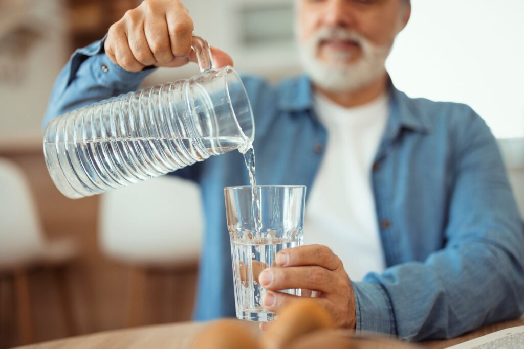 older man pouring water