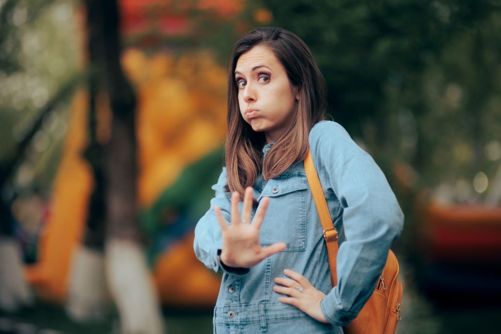 adult woman with hand out expressing that she's setting boundaries