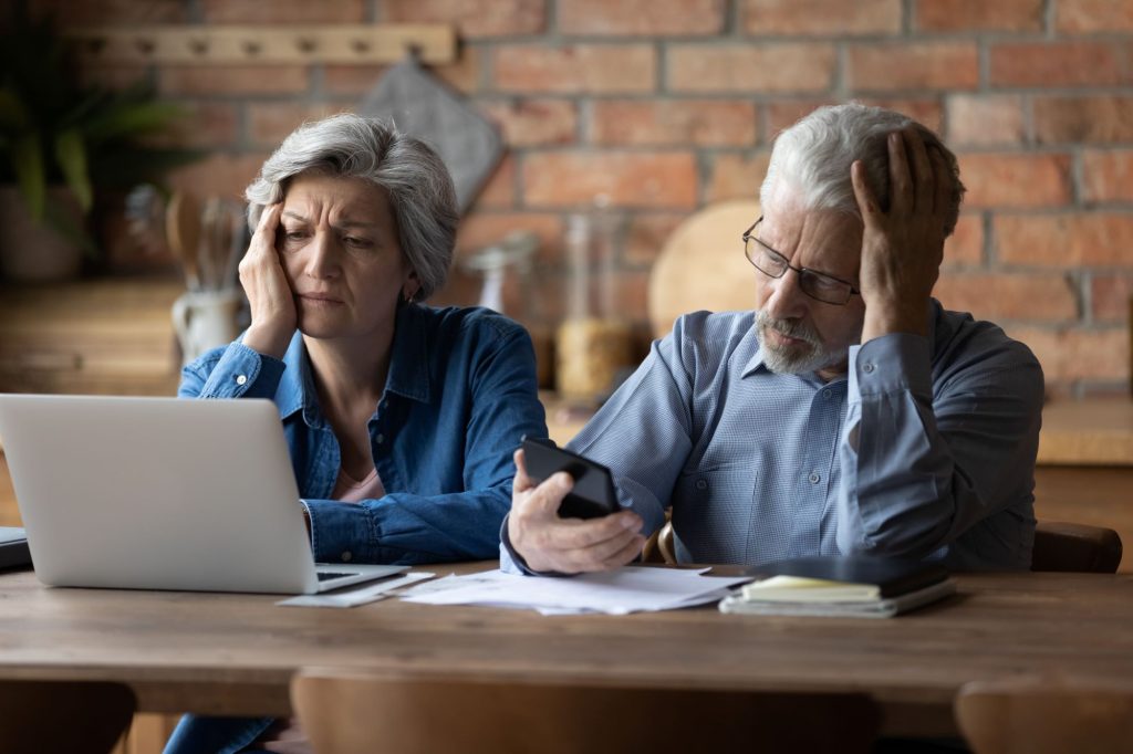 confused couple looking at a computer screen