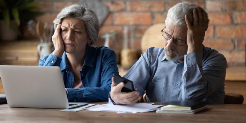 confused couple looking at a computer screen
