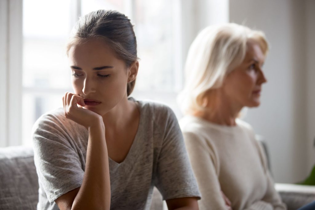 distraught adult child presumably in a disagreement with senior, retiree mother