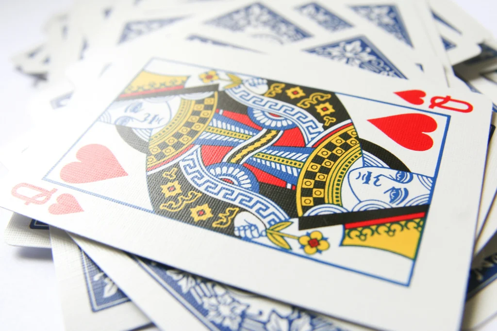 playing cards with the queen of hearts on top