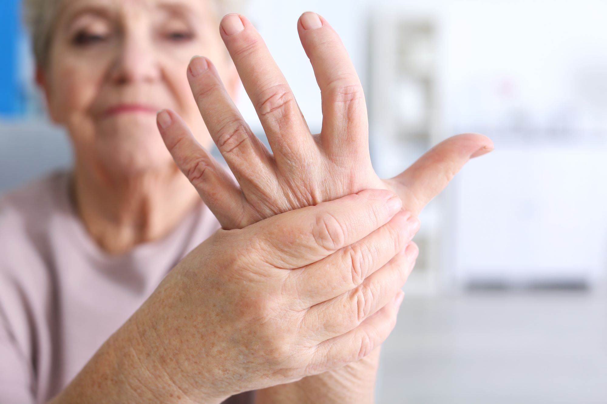 senior woman holding hand illustrating joint health