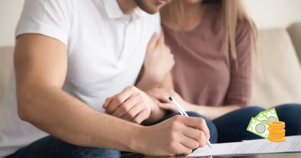 couple signing papers, with dollars and cents nearby implying that there's a cost