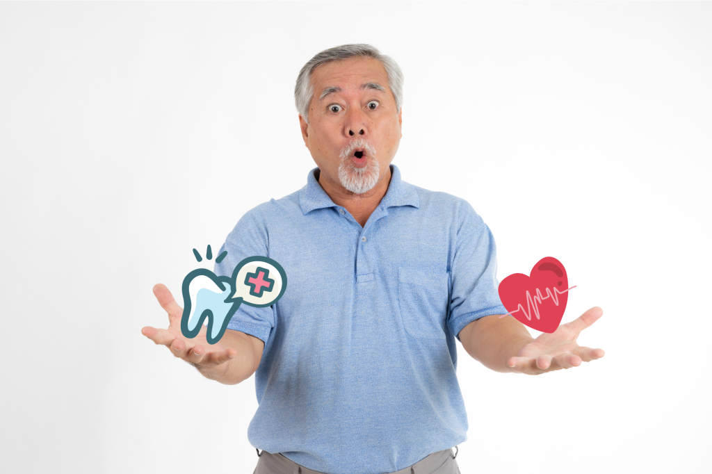 Asain senior man holding tooth and heart emojis with a surprised face