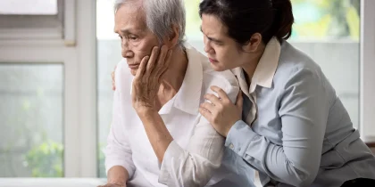 Loving daughter embracing comforting and consoling the old elderly, depressed stressed senior woman contemplating,afraid and worried about senile disease,thinking about health problems,life troubles maybe with alzheimer's disease