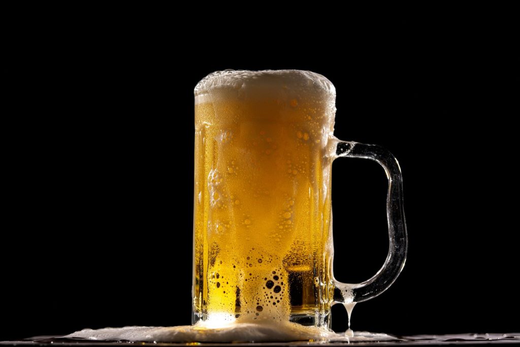 cup of beer on black background