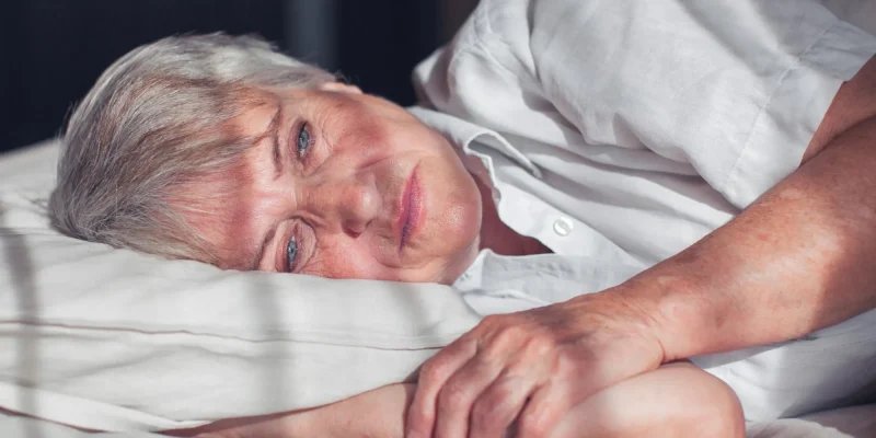 Sleepless middle-aged woman lying in bed suffers from insomnia sleep disorder cant sleep till morning, depressed elderly female looking upset thinking about life, health troubles concept