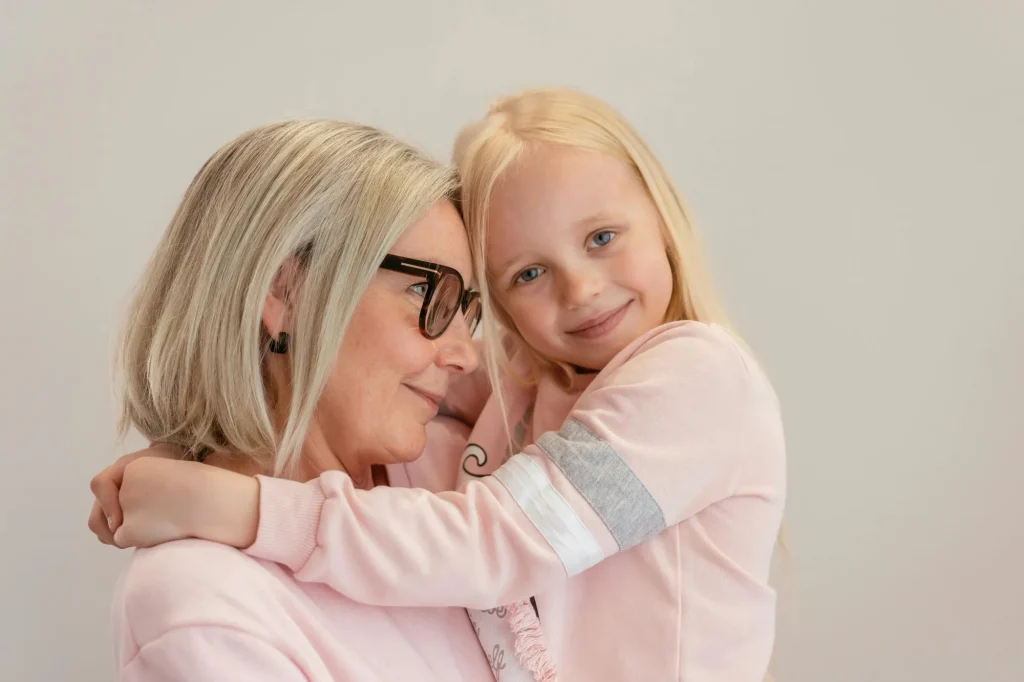 grandmother and grandchild, grandma holding granddaughter in arms