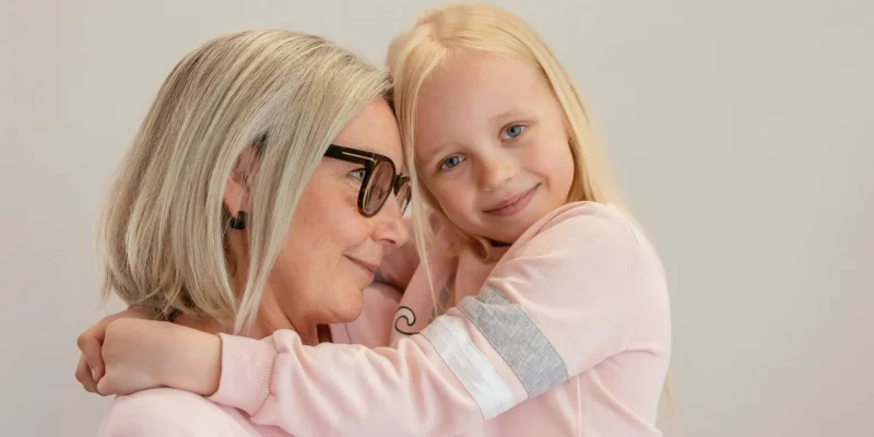 grandmother and grandchild, grandma holding granddaughter in arms