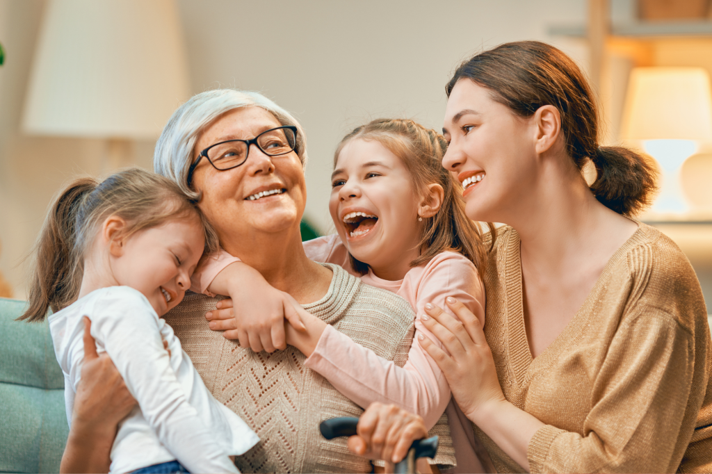 grandma with granddauthers and daughter smiling
