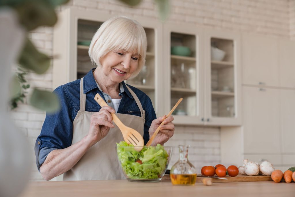 senior woman cooking a healthy meal