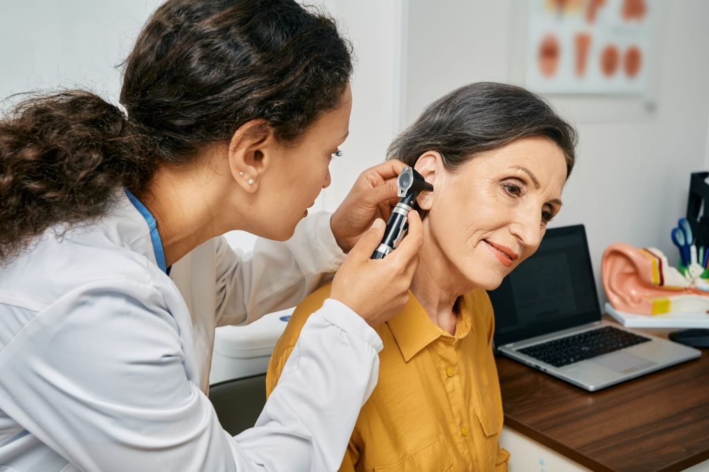 doctor examining patient's ear