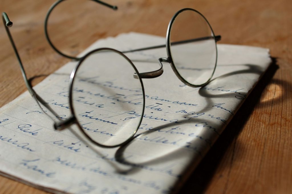a letter with glasses on top