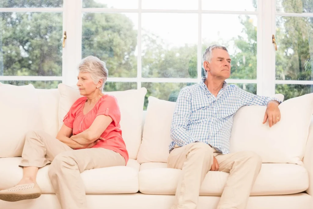 Senior couple not speaking after an argument on the sofa