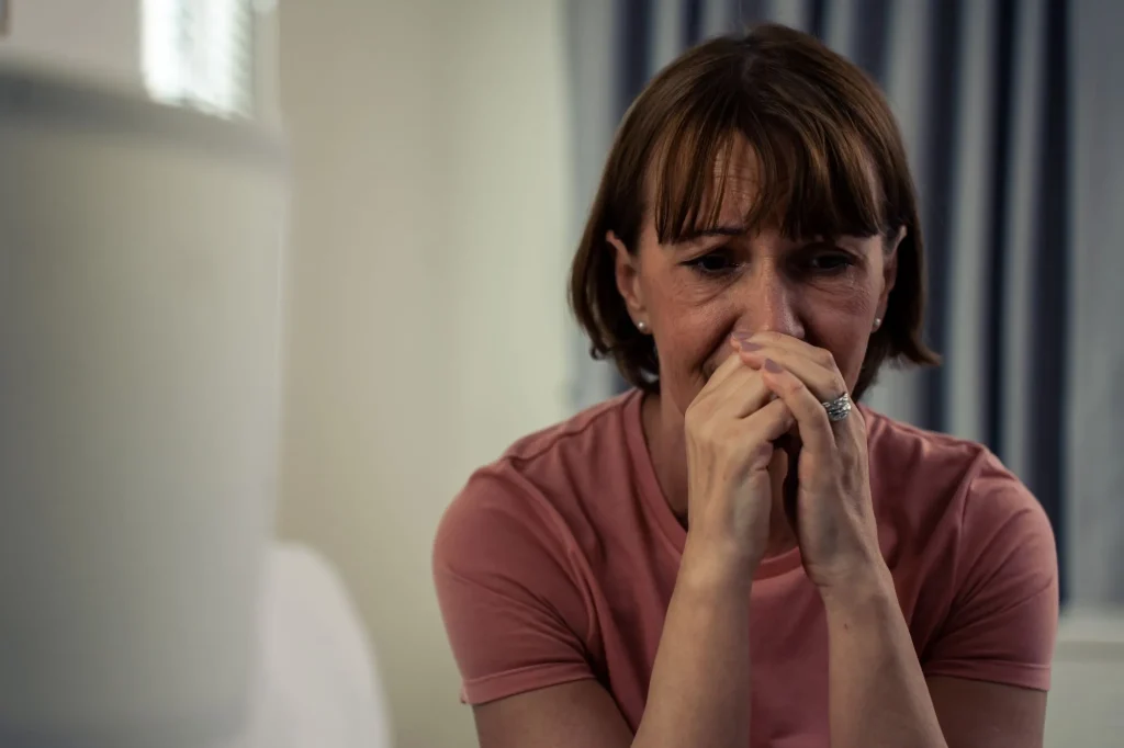 Caucasian senior older depressed woman sit alone in bedroom at home