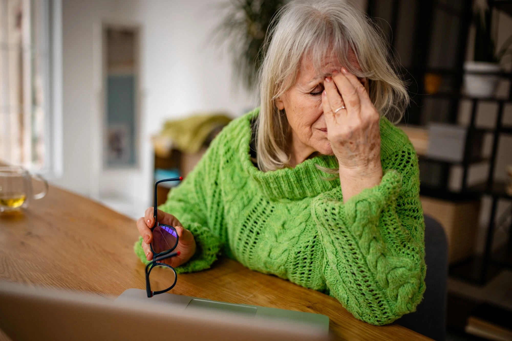 lady in a green strain dealing with eye strain