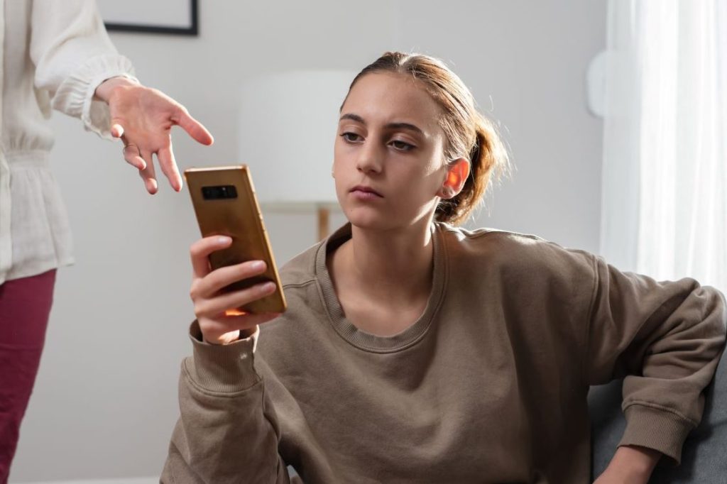 teen on phone ignoring grandparent