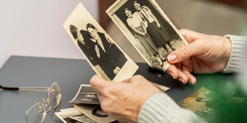 hands looking at old photos
