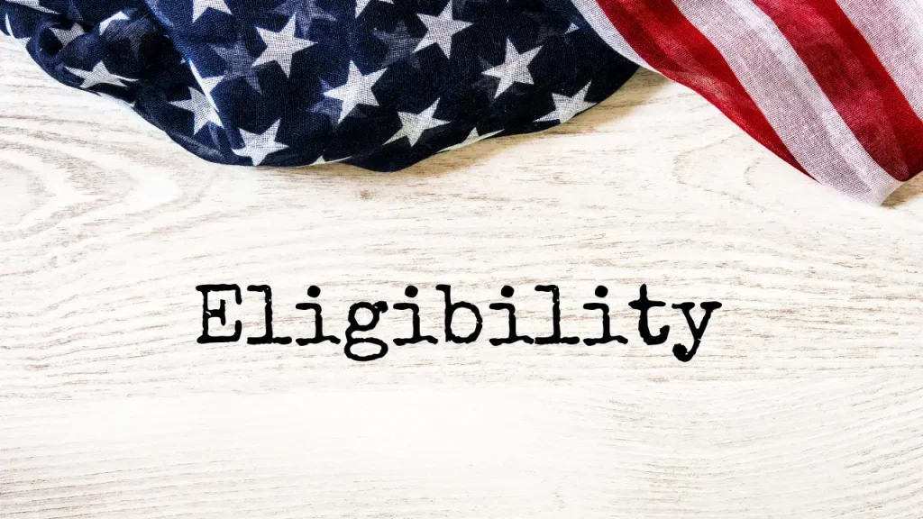 Eligibility written with typewriter on wooden background with an american flag at the top of the photo
