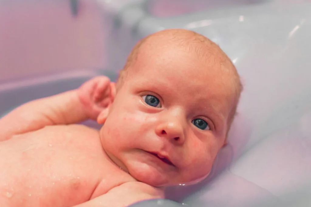 newborn baby getting a bath