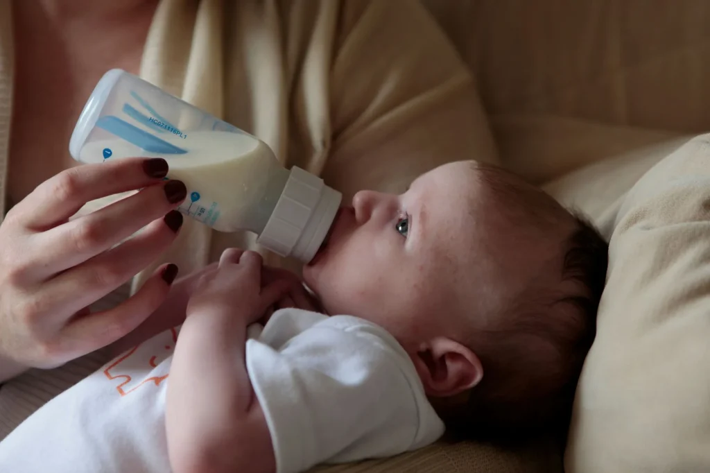 newborn baby drinking a bottle