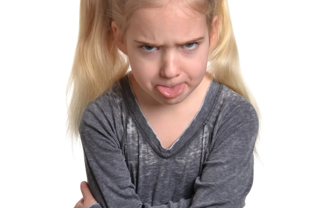 bratty child with tongue out