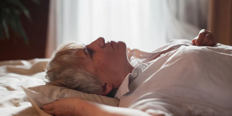 Middle aged mature woman insomniac lying awake in bed looking up trying to sleep, unhappy old senior lady feel disturbed frustrated suffer from insomnia concept uncomfortable bad mattress