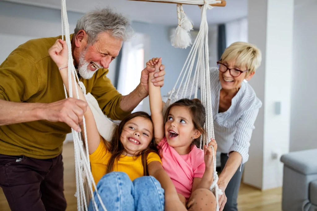 Grandchildren having fun, playing with grandparents at home