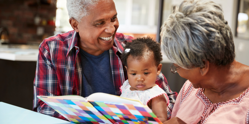 grandparents reading to baby