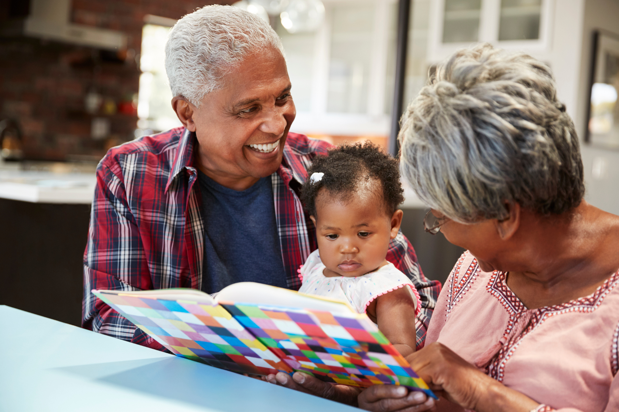 grandparents reading to baby
